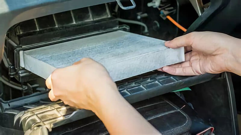 Suzuki car cabin filter being replaced, demonstrating maintenance process