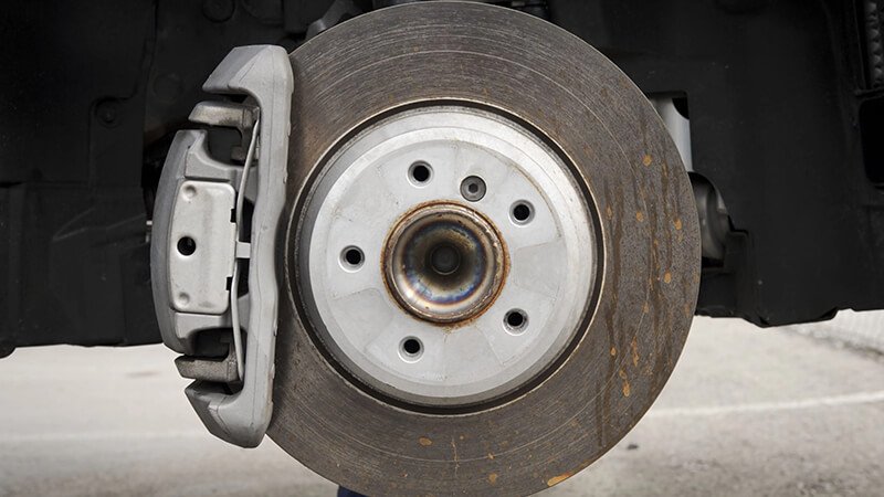 Close-up of a car brake rotor with caliper attached