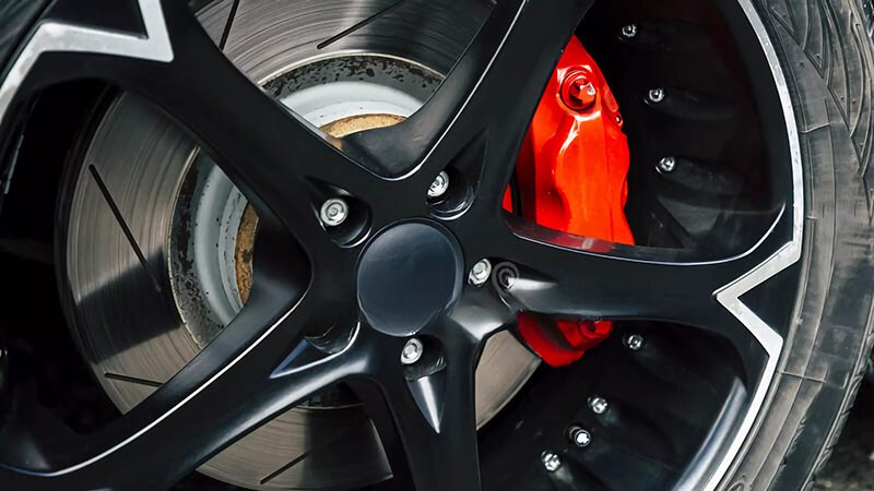 Red high-performance brake calipers installed on a modern sports car