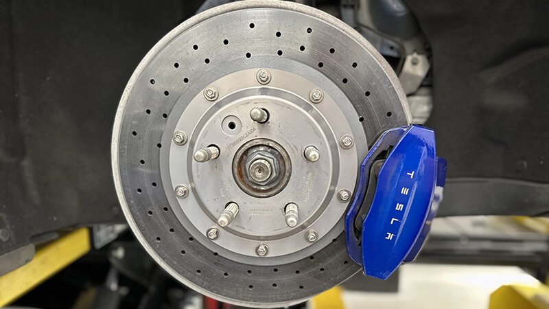 Tesla brake system, A modern brake pad and rotor setup for electric vehicles ensuring optimal performance.