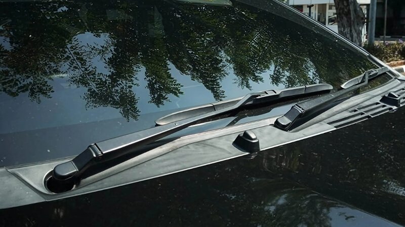 Windshield wipers on black car parked outside