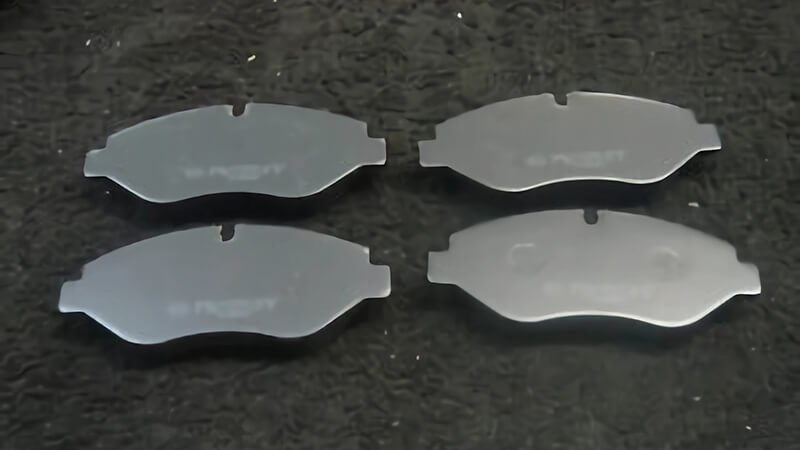 Backplate view of four brake pads