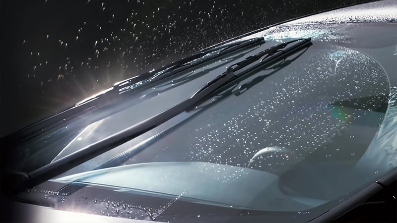 Windshield wipers on glass under heavy rain
