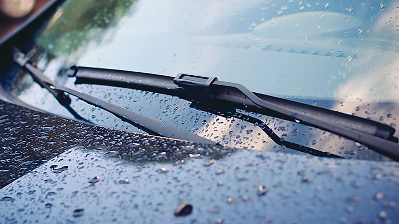 Water droplets on windshield with wiper blade